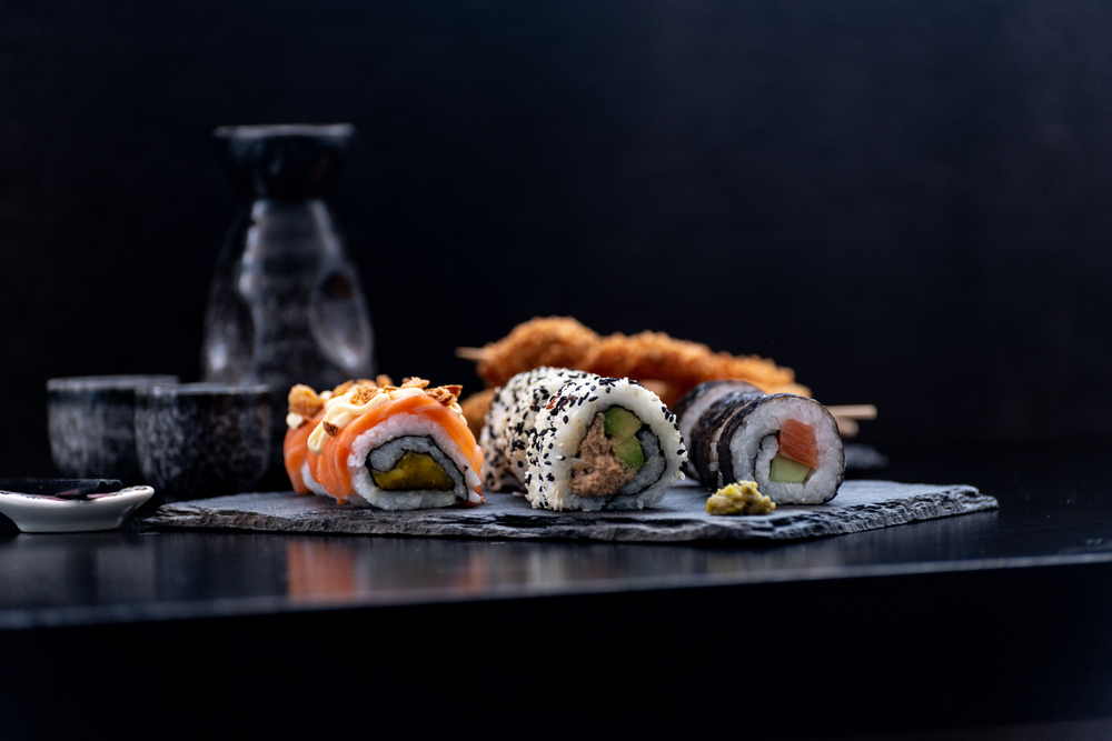 A sushi dish involves cooked medium-grained rice mixed with vinegar, served with raw or cooked seafood