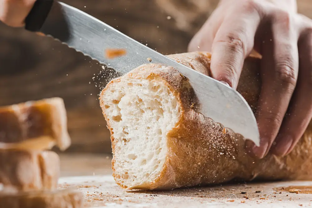 A breadknife is designed to cut easily across the crust of a loaf without crushing
